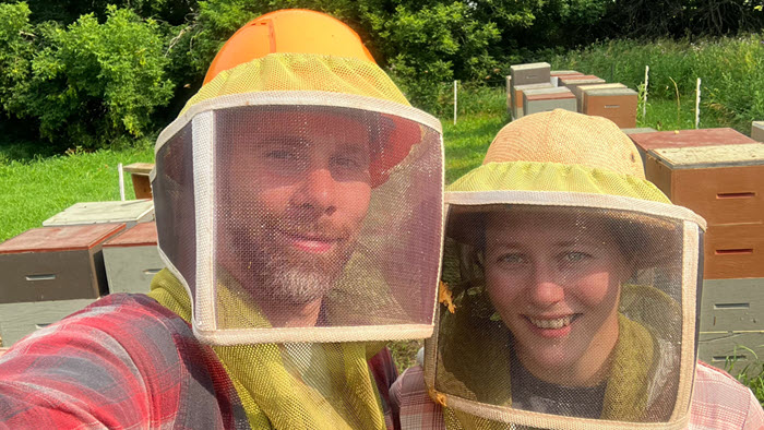 Tim and Victoria in the bee keeping yard with their beekeeping veils